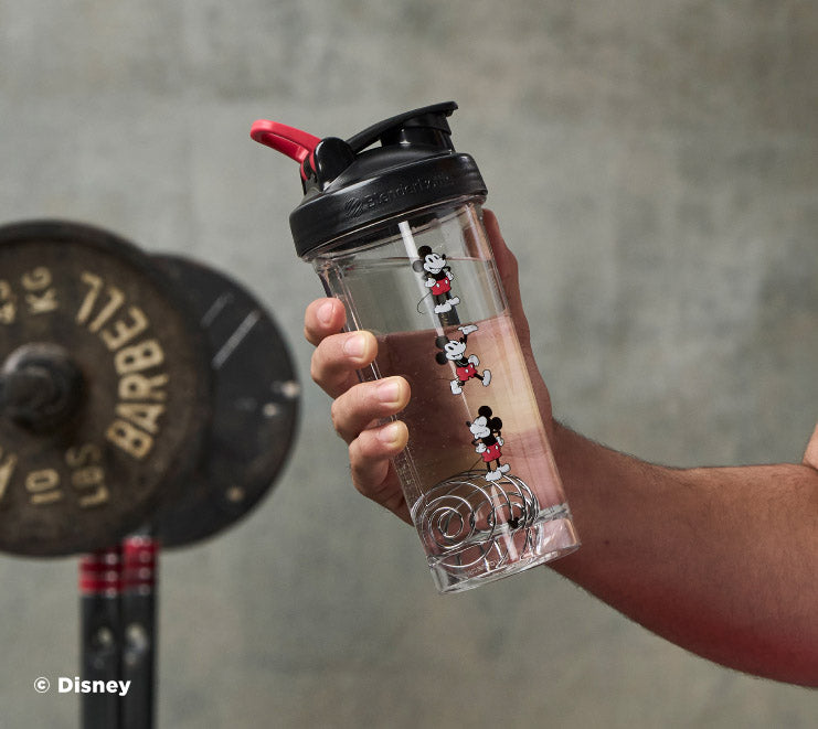 pro-series-k6 Mickey_Mouse_Protein_Shaker_Bottle_Being_Held_In_the_Gym.jpg